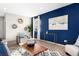 Contemporary living room with a stylish accent wall, modern art, and comfortable seating arrangements at 12715 E 104Th Pl, Commerce City, CO 80022
