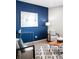 Corner of stylish living room featuring a bold blue wall, modern decor, and comfortable seating at 12715 E 104Th Pl, Commerce City, CO 80022