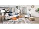Open-concept living room with a view to the front door, a cozy seating area, and modern decor at 12715 E 104Th Pl, Commerce City, CO 80022