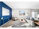Stylish living room featuring a bold accent wall, modern furnishings, and ample seating space at 12715 E 104Th Pl, Commerce City, CO 80022