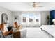 Bright main bedroom with large windows, plush rug, and stylish decor at 12715 E 104Th Pl, Commerce City, CO 80022