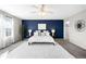 Inviting main bedroom featuring a cozy rug, accent wall, and elegant furnishings at 12715 E 104Th Pl, Commerce City, CO 80022