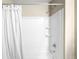 Clean white shower with built-in shelving and a shower curtain at 12715 E 104Th Pl, Commerce City, CO 80022