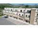 Aerial view of a commercial building and parking lot surrounded by mountains at 615 24Th St # 104, Golden, CO 80401
