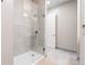 Bathroom with a glass-enclosed shower and a tile surround with modern fixtures and neutral tones at 615 24Th St # 104, Golden, CO 80401