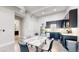 Eat-in kitchen with a marble table, stainless steel appliances, and dark blue cabinets at 615 24Th St # 104, Golden, CO 80401