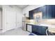 Modern kitchen with stainless steel appliances, dark blue cabinets, and a bright white backsplash at 615 24Th St # 104, Golden, CO 80401