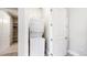 Convenient laundry area with stacked washer and dryer, and shelving for storage at 615 24Th St # 104, Golden, CO 80401