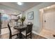 Eat-in kitchen with a dining table, updated cabinets, stainless steel appliances, and a view into the dining room at 12685 E Pacific Cir # B, Aurora, CO 80014