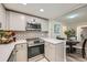 Well-lit kitchen with stainless steel appliances, updated cabinets, counter tops, and an eat-in nook at 12685 E Pacific Cir # B, Aurora, CO 80014