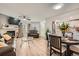 Bright living room with a fireplace, modern decor, dining area, and open access to the kitchen at 12685 E Pacific Cir # B, Aurora, CO 80014