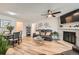 Cozy living room featuring a fireplace, ceiling fan, and modern decor and dining table at 12685 E Pacific Cir # B, Aurora, CO 80014