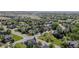 Expansive aerial view of a well-planned neighborhood with mature trees, green spaces, and diverse housing options at 16158 Whitestone Dr, Parker, CO 80134