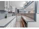 Basement bar area featuring modern white countertop and a tile backsplash with white cabinets for storage at 16158 Whitestone Dr, Parker, CO 80134