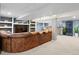 Spacious finished basement with a large leather sectional, built-in shelves, and a bar area for entertaining at 16158 Whitestone Dr, Parker, CO 80134