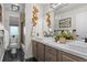 Modern bathroom featuring double sinks, marble countertops, and decorative wall accents at 16158 Whitestone Dr, Parker, CO 80134