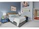 Comfortable bedroom featuring blue walls, plush carpeting, decorative art, and comfortable furnishings at 16158 Whitestone Dr, Parker, CO 80134