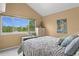 Comfortable bedroom with vaulted ceilings, a scenic window view, and a calming ambiance at 16158 Whitestone Dr, Parker, CO 80134