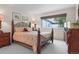 Cozy bedroom with a wrought-iron bed, a large window, and neutral decor at 16158 Whitestone Dr, Parker, CO 80134