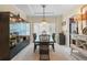 Elegant dining room with a chandelier, a black table with seating for six, and custom display cabinets at 16158 Whitestone Dr, Parker, CO 80134