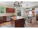 Open-concept kitchen with an island, stainless steel appliances, and a view of the dining area at 16158 Whitestone Dr, Parker, CO 80134