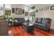 Cozy living room with hardwood floors, comfortable leather furniture, and bright natural light at 16158 Whitestone Dr, Parker, CO 80134