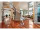 Inviting living room with hardwood floors, staircase, and lots of natural light at 16158 Whitestone Dr, Parker, CO 80134