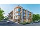 Modern apartment building featuring multiple balconies, large windows, and street-level storefronts at 1643 Boulder St # 209, Denver, CO 80211