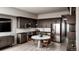 Modern kitchen features stainless steel appliances, dark wood cabinets, and a marble table at 1643 Boulder St # 209, Denver, CO 80211