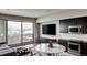 Bright living room with large windows, a modern kitchen, and comfortable seating area at 1643 Boulder St # 209, Denver, CO 80211