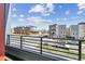 Neighborhood view from a balcony with black railing and street views at 1299 Osceola St, Denver, CO 80204