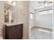 Modern bathroom featuring sleek vanity with contemporary fixtures next to an adjoining bedroom at 1299 Osceola St, Denver, CO 80204