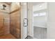 Stunning walk-in shower with luxurious tile work and glass door next to an adjoining bedroom at 1299 Osceola St, Denver, CO 80204