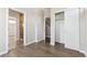 Spacious bedroom showcasing bathroom access, walk-in closet, and sleek hardwood flooring at 1299 Osceola St, Denver, CO 80204