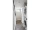 Hallway with stacked washer and dryer and stairs at 1299 Osceola St, Denver, CO 80204