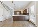 Open kitchen and living area featuring hardwood floors and modern appliances and island at 1299 Osceola St, Denver, CO 80204