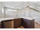 Kitchen with stainless steel appliances, light countertops and view of staircase at 1299 Osceola St, Denver, CO 80204
