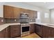 Modern kitchen with stainless steel appliances, sleek cabinets and light countertops at 1299 Osceola St, Denver, CO 80204