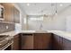 Well-lit kitchen boasts stainless steel appliances and open layout to a dining area at 1299 Osceola St, Denver, CO 80204