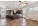 Modern kitchen with stainless steel appliances, island, hardwood floors, and ceiling fan at 1299 Osceola St, Denver, CO 80204
