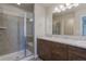 Bathroom features a walk-in shower, double sink vanity, and modern fixtures at 814 N Bently St, Watkins, CO 80137