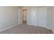 Bright bedroom features a closet and neutral walls with plush carpeting at 814 N Bently St, Watkins, CO 80137