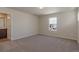 Bright bedroom features a window, neutral walls, and plush carpeting at 814 N Bently St, Watkins, CO 80137