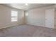 A spacious bedroom with a window, neutral walls, and plush carpeting at 814 N Bently St, Watkins, CO 80137