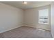 Bright bedroom features a window, neutral walls, and plush carpeting at 814 N Bently St, Watkins, CO 80137