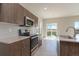Spacious kitchen with stainless steel appliances and natural light at 814 N Bently St, Watkins, CO 80137
