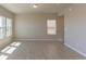 Spacious living room with light walls and flooring and large windows at 814 N Bently St, Watkins, CO 80137