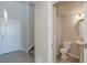 View of powder room showcasing a pedestal sink and commode at 814 N Bently St, Watkins, CO 80137