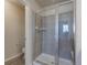 A glass enclosed walk-in shower with tile surround and built-in bench at 814 N Bently St, Watkins, CO 80137