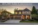 Inviting two-story home featuring a stone facade, well-manicured lawn, and a two-car garage, offering an appealing curb appeal at 4307 Lilly Gulch Trl, Castle Rock, CO 80109